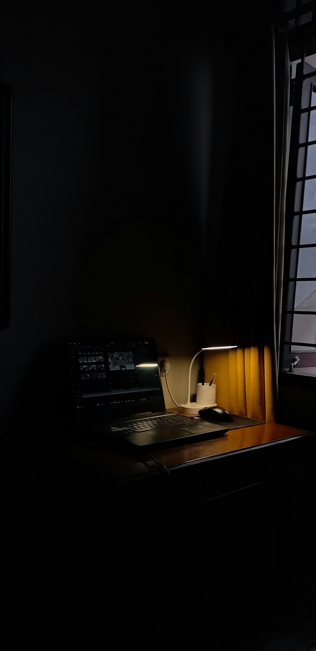 writer typing on laptop in dark room